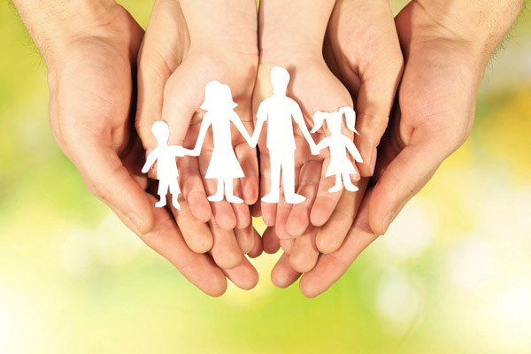 image of paper family in hands depicting heating oil safety