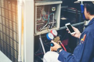 professional HVAC technician working on compressor