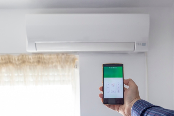 ductless air conditioner controlled on smartphone depicting advancement in cooling technology