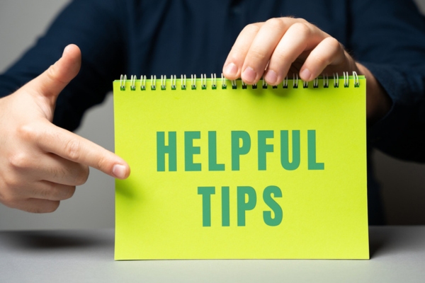 man pointing on helpful tips written on spring notebook