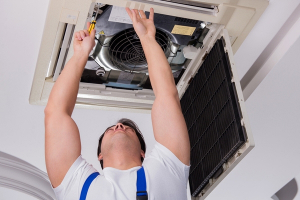 HVAC technician repairing air conditioner