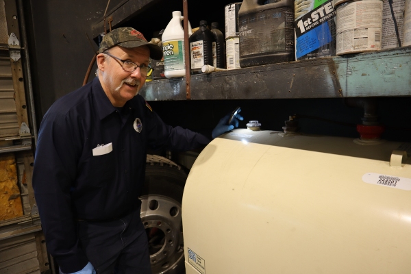 Lake Region Energy technician inspecting home heating oil tank installed indoors