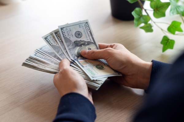 man counting money depicting HVAC replacement costs