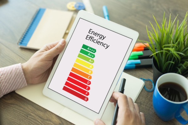 man reading about energy efficiency on his tablet