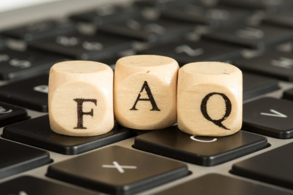 FAQ spelled using wooden letter blocks on top of a keyboard