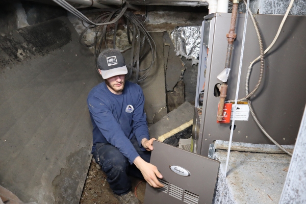 Lake Region Energy HVAC technician repairing a furnace depicting source of indoor carbon monoxide