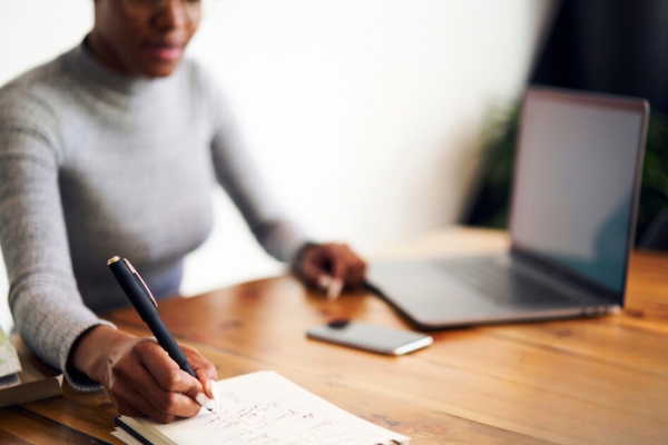 Woman computing and evaluating propane consumption at home