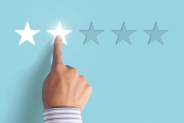 hand choosing 2 stars on rating depicting low efficiency rating on heating system