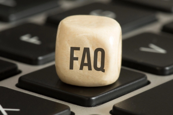 FAQ written on a wooden block on top of a keyboard key depicting questions about boiler performance and water quality