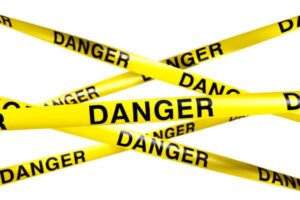 danger on yellow tape depicting empty propane tank