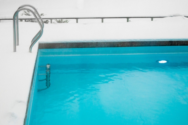 swimming pool sides covered with snow