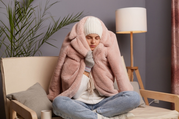 woman feeling cold indoors due to heating disruption caused by propane depletion